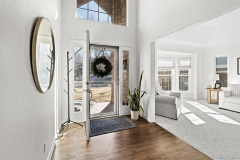 a view of entryway and hall with wooden floor