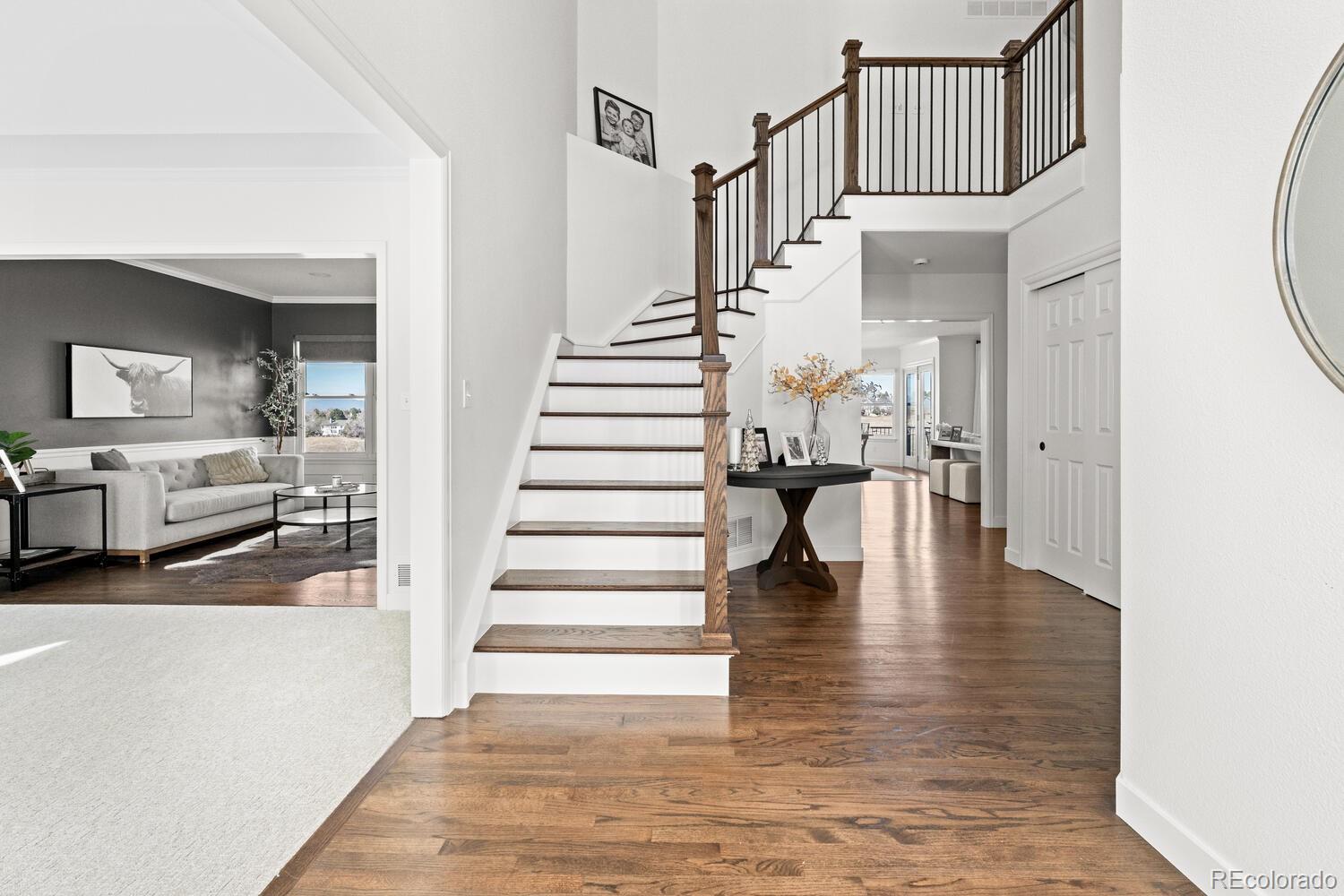 8855 South Wild Iris Run Highlands Ranch, CO 80126 - Photo 6 of 48 a view of entryway and hall with wooden floor