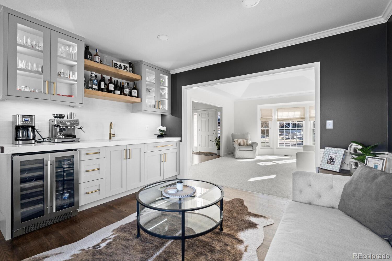 8855 South Wild Iris Run Highlands Ranch, CO 80126 - Photo 10 of 48 a living room with furniture a rug kitchen view and a window