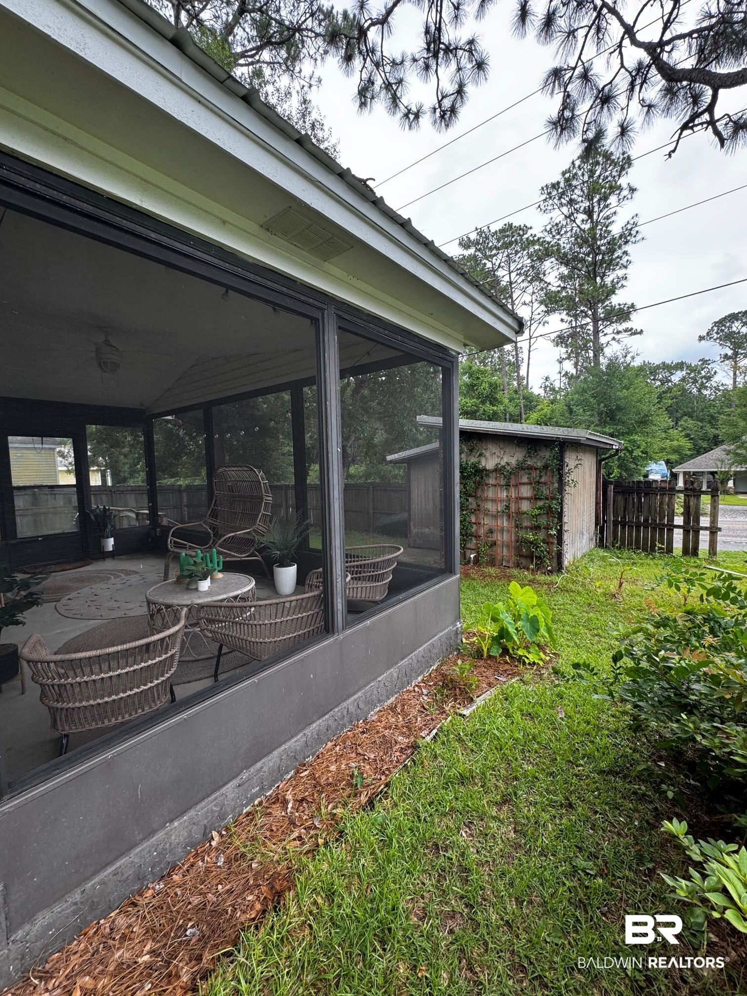 1434 Ridgewood Drive Lillian, AL 36549 - Photo 22 of 45 View of yard with a sunroom and a patio