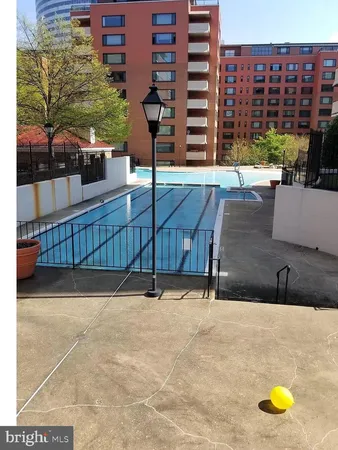 a view of swimming pool with outdoor seating and city view