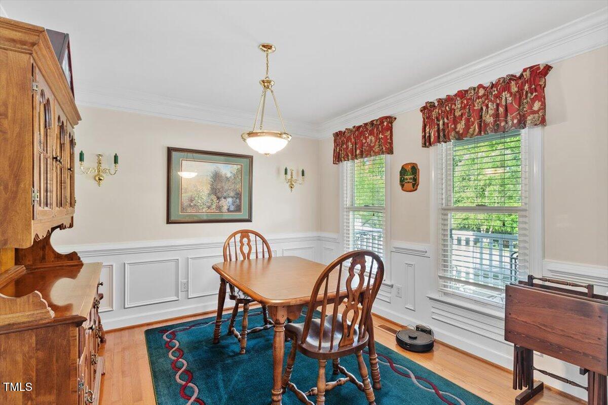 9204 Cub Trail Raleigh, NC 27615 - Photo 3 of 21 a dining room with furniture a chandelier and wooden floor
