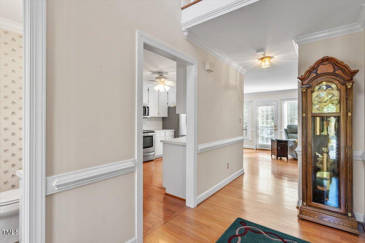 9204 Cub Trail Raleigh, NC 27615 - Photo 4 of 21 a view of a hallway with wooden floor windows and livingroom