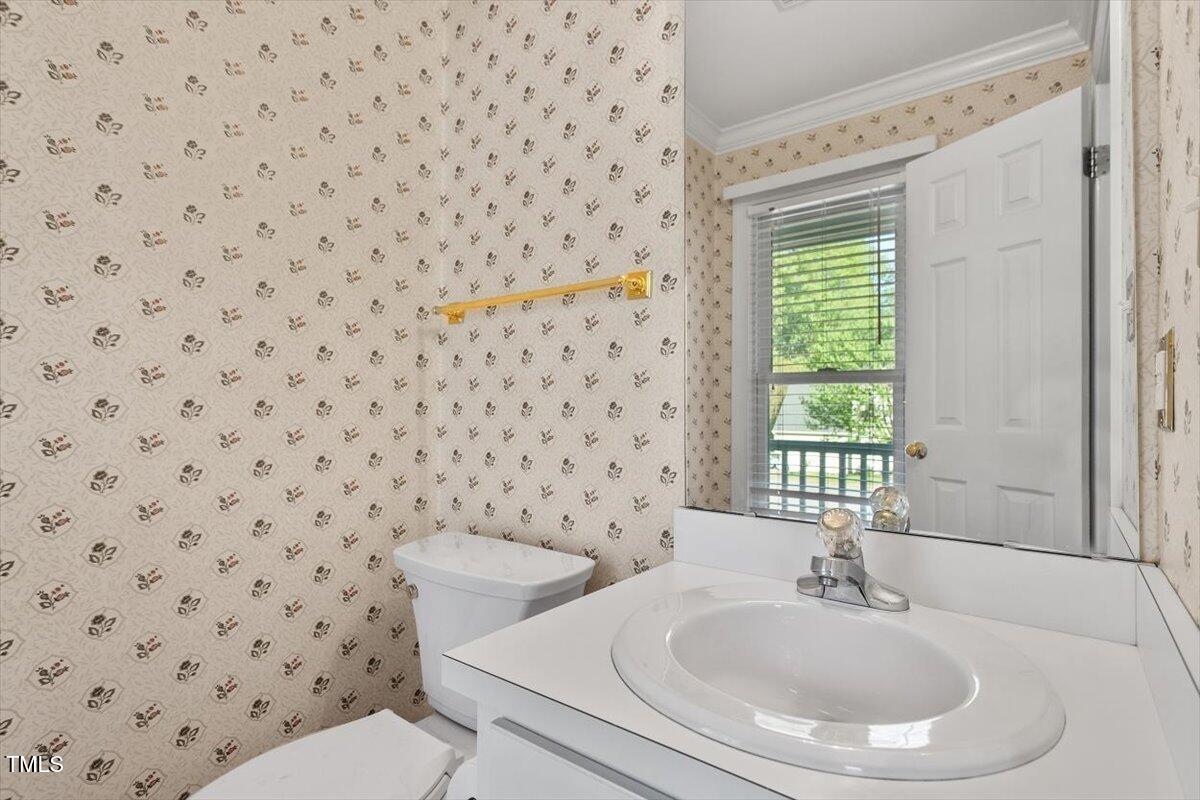 9204 Cub Trail Raleigh, NC 27615 - Photo 5 of 21 a bathroom with a sink a toilet and a mirror