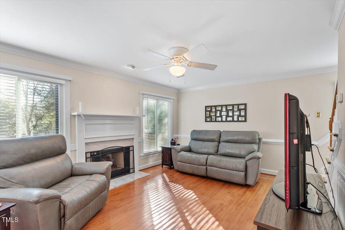 9204 Cub Trail Raleigh, NC 27615 - Photo 9 of 21 a living room with furniture flat screen tv and a fireplace