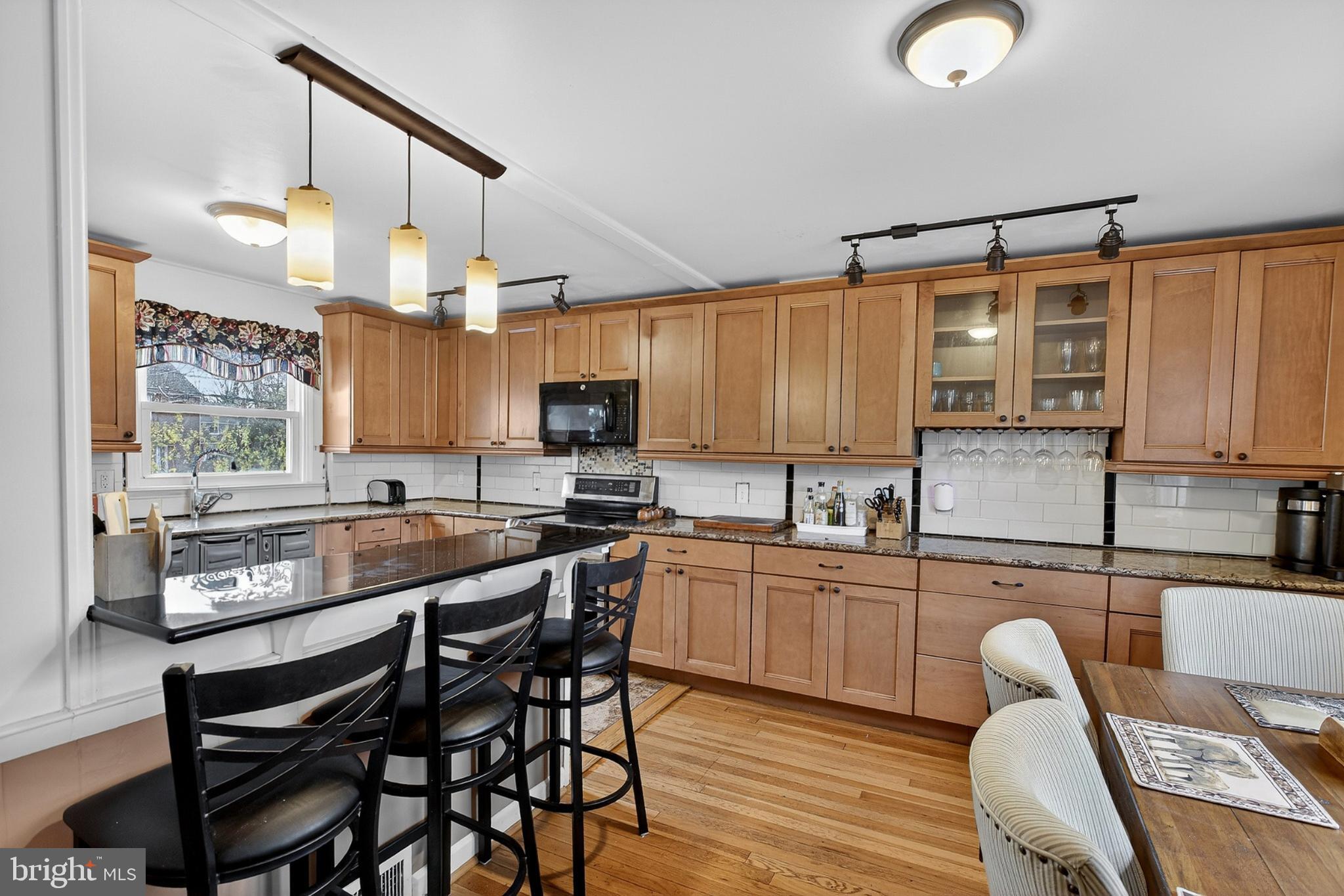 214 Waverly Road Wilmington, DE 19803 - Photo 8 of 47 Warm wood tones in a modern kitchen space.