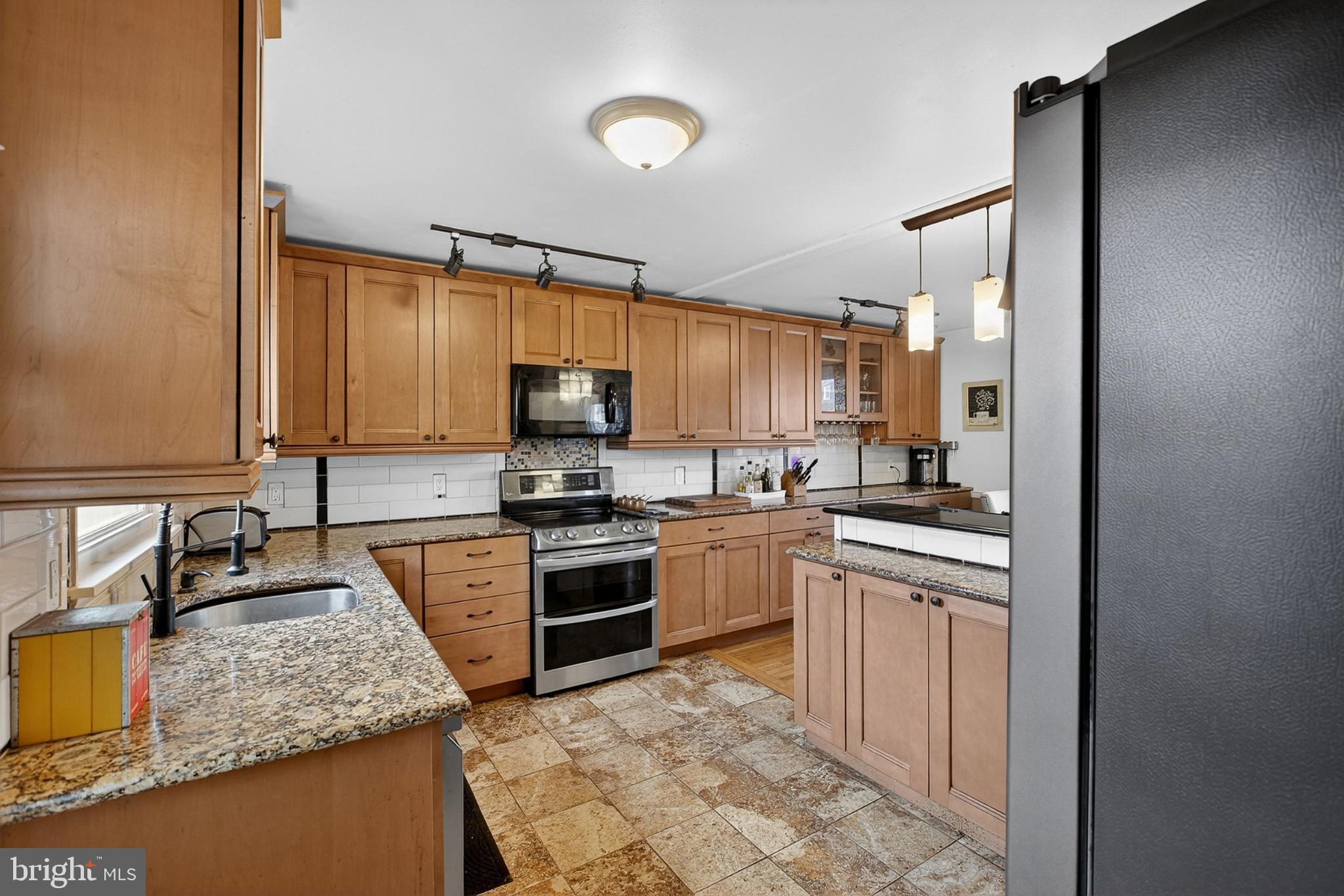 214 Waverly Road Wilmington, DE 19803 - Photo 9 of 47 Modern kitchen with warm wood cabinetry.