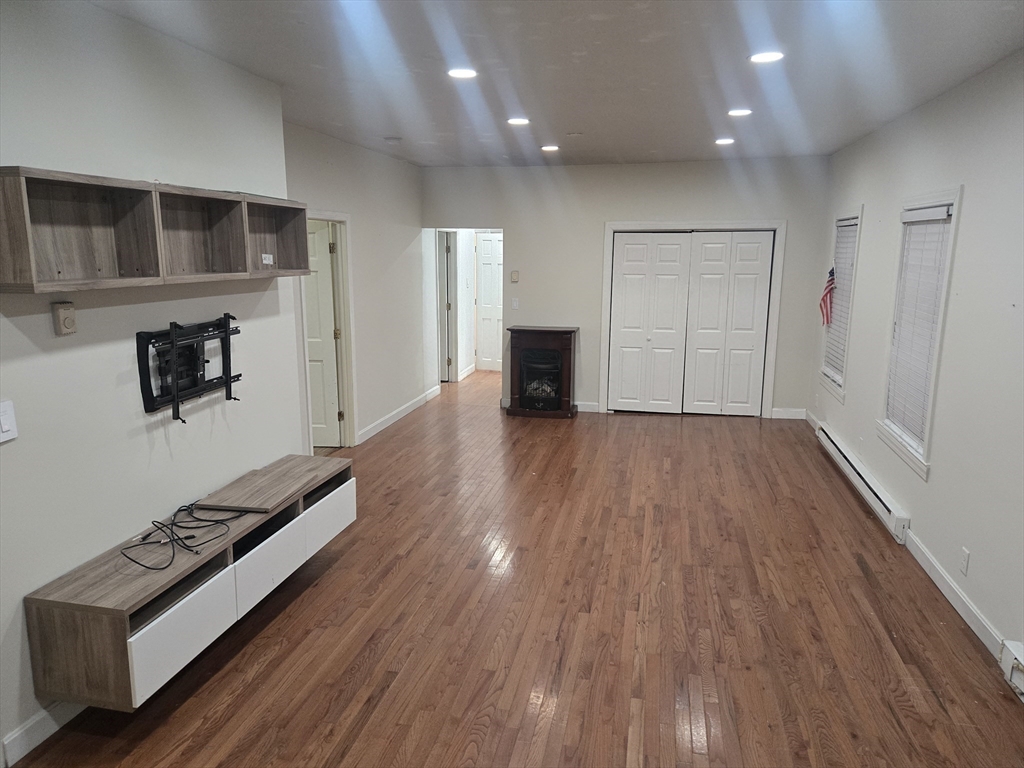 380 Grafton Street, Unit 1 Worcester, MA 01604 - Photo 3 of 8 a view of an empty room with wooden floor