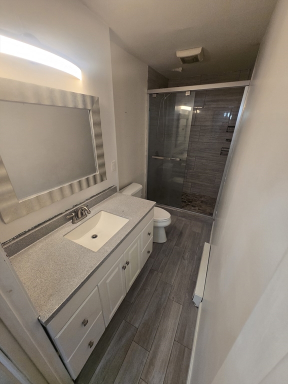 380 Grafton Street, Unit 1 Worcester, MA 01604 - Photo 5 of 8 a bathroom with a double vanity sink toilet and mirror