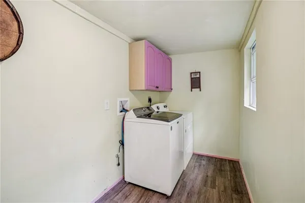 a view of front door and porch with wooden floor