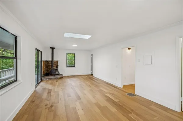 a view of kitchen with microwave stove top oven and cabinets