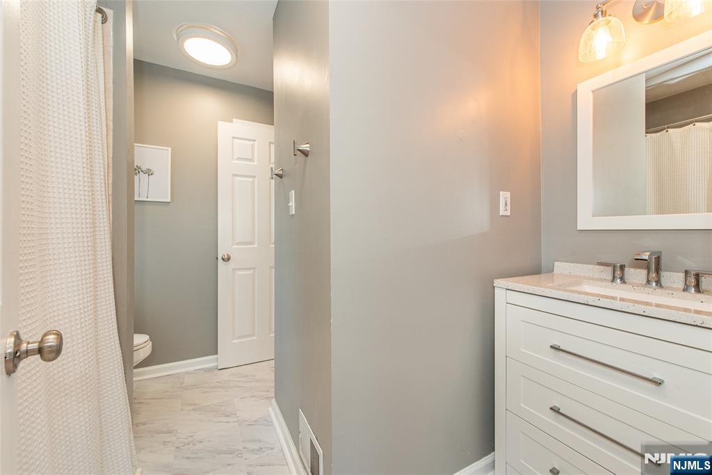 15 Orange Road Denville, NJ 07834 - Photo 16 of 24 a bathroom with a sink vanity granite and a mirror