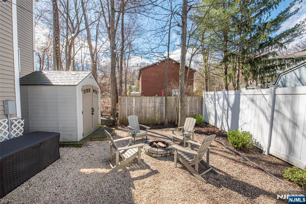 15 Orange Road Denville, NJ 07834 - Photo 22 of 24 a backyard of a house with table and chairs