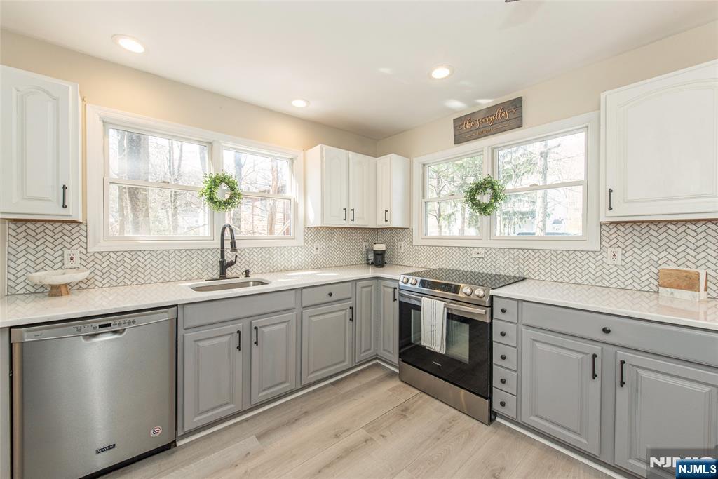 15 Orange Road Denville, NJ 07834 - Photo 6 of 24 a kitchen with a sink stove and cabinets
