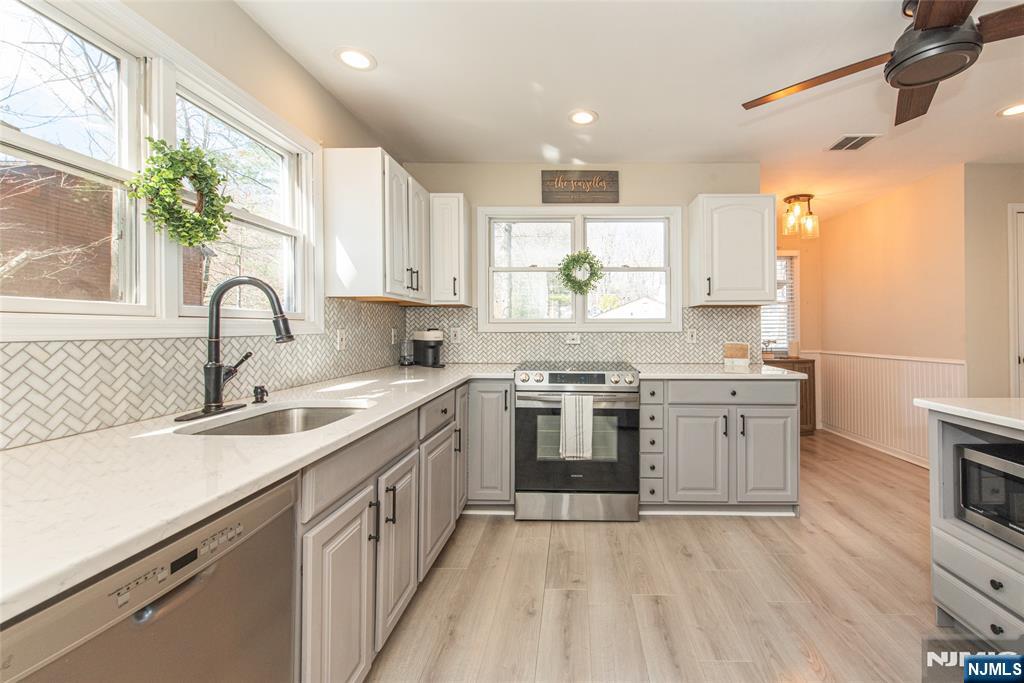 15 Orange Road Denville, NJ 07834 - Photo 7 of 24 a kitchen with a sink stove and cabinets