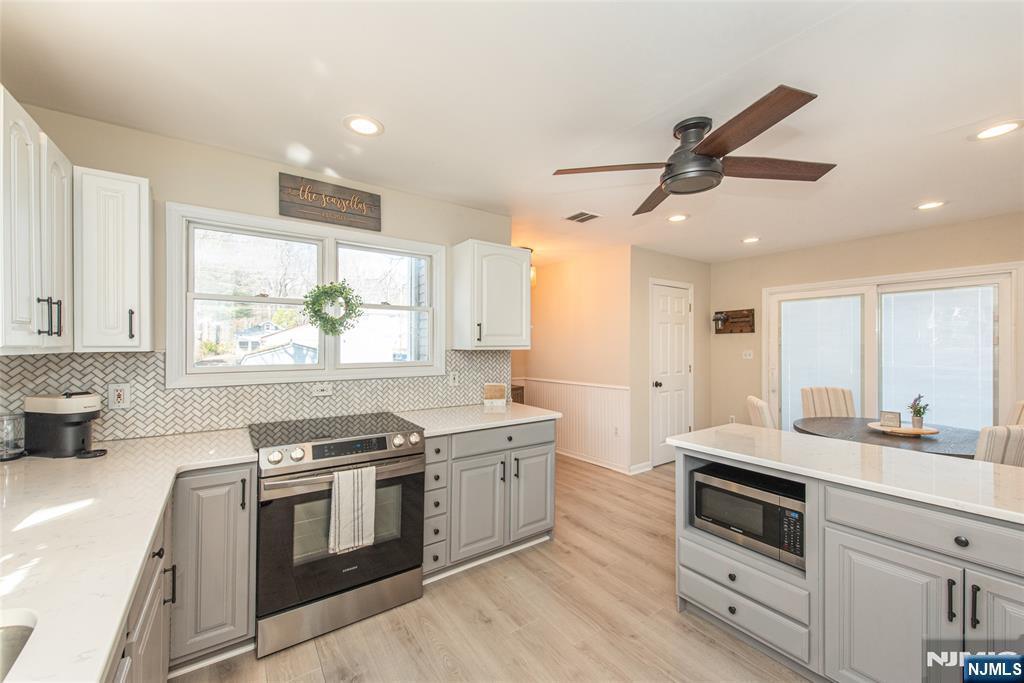 15 Orange Road Denville, NJ 07834 - Photo 8 of 24 a kitchen with stainless steel appliances granite countertop a stove and a sink