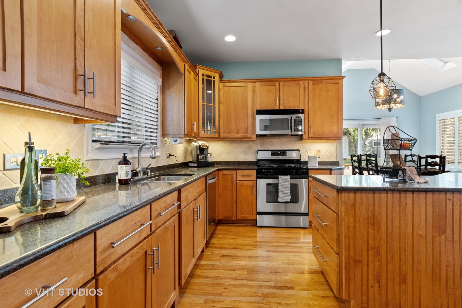 5S590 Radcliff Road Naperville, IL 60563 - Photo 6 of 27 a kitchen with stainless steel appliances granite countertop a stove a sink and a microwave