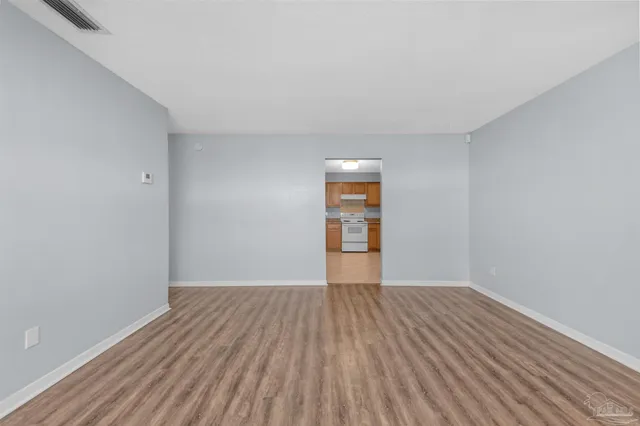 a view of a room with wooden floor and brick walls