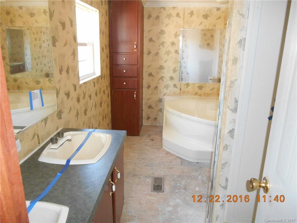 1758 Millen Road, Unit 8 Chester, SC 29706 - Photo 6 of 13 a bathroom with a tub sink and mirror