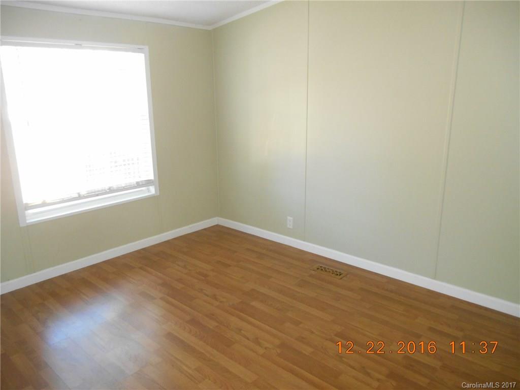 1758 Millen Road, Unit 8 Chester, SC 29706 - Photo 8 of 13 an empty room with wooden floor and windows