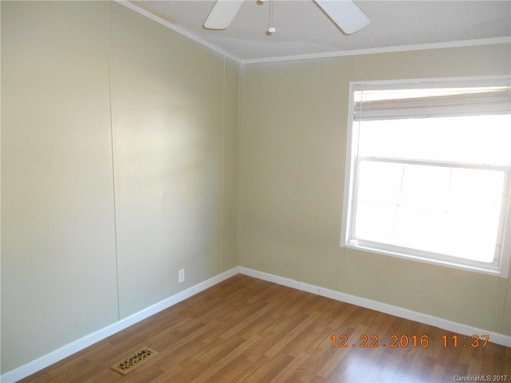 1758 Millen Road, Unit 8 Chester, SC 29706 - Photo 9 of 13 a view of an empty room with wooden floor and a window