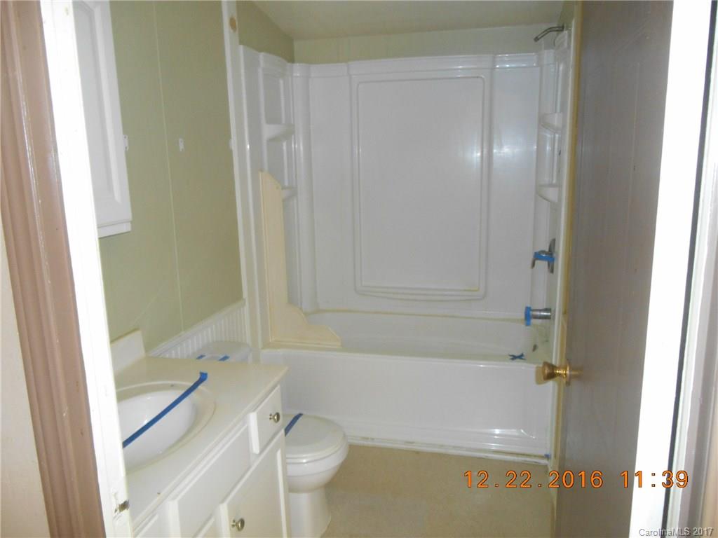 1758 Millen Road, Unit 8 Chester, SC 29706 - Photo 10 of 13 a bathroom with a granite countertop bathtub shower and toilet