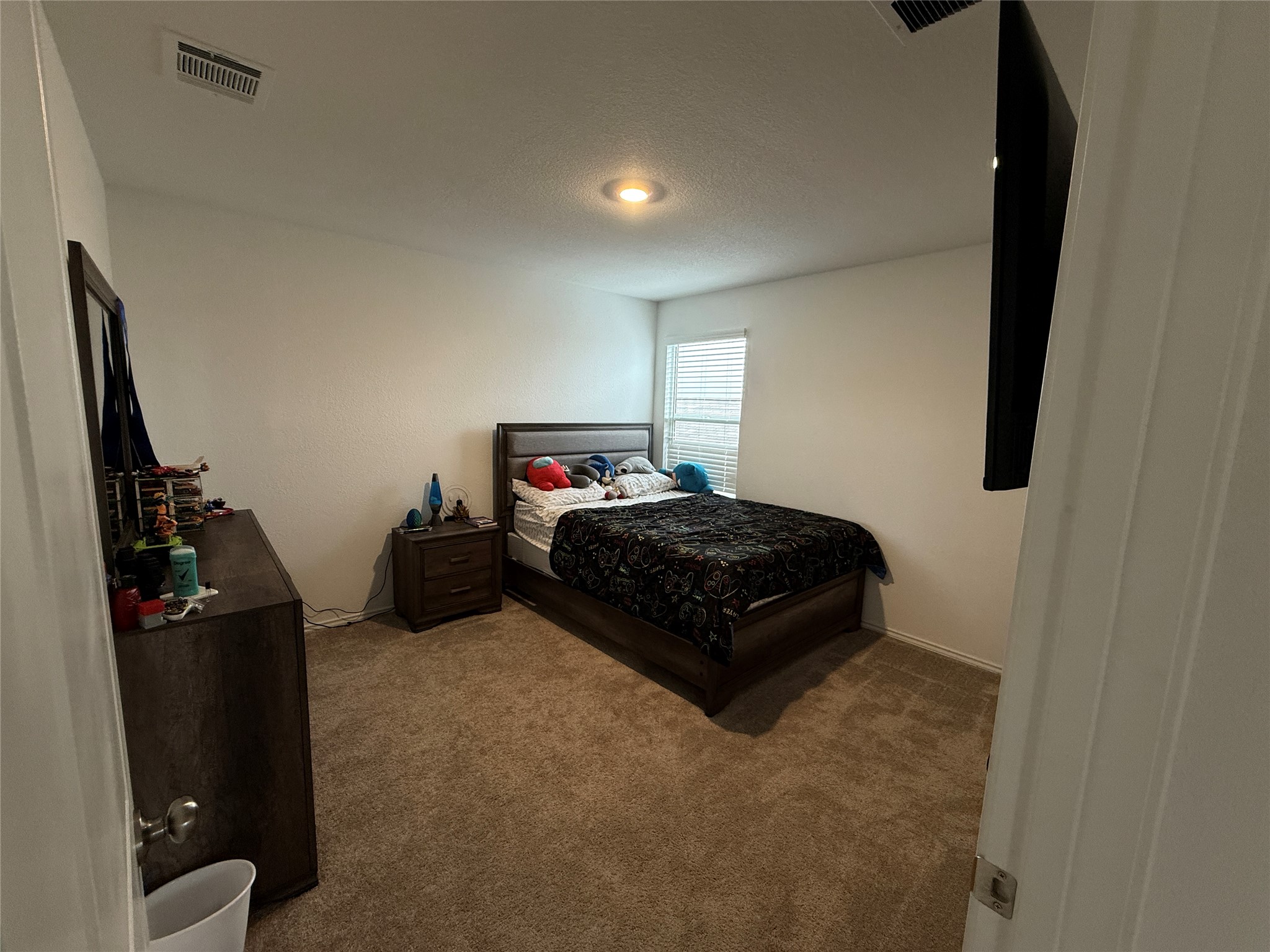 23420 Tiny Moons Way Elgin, TX 78621 - Photo 16 of 22 a bedroom with a bed and dresser