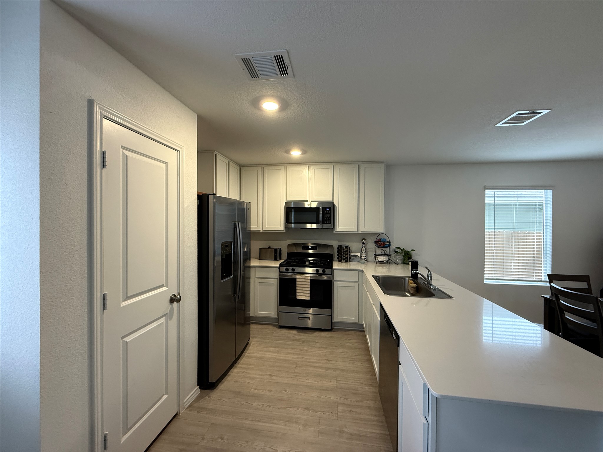 23420 Tiny Moons Way Elgin, TX 78621 - Photo 5 of 22 a kitchen with refrigerator and cabinets