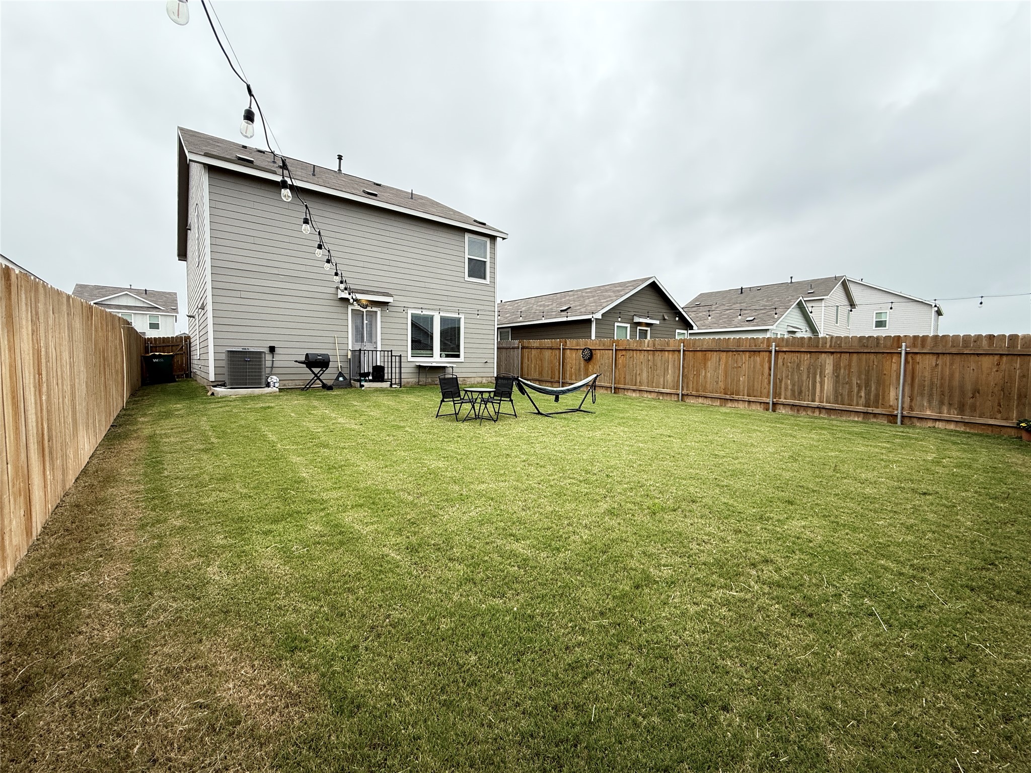 23420 Tiny Moons Way Elgin, TX 78621 - Photo 7 of 22 a view of a house with a yard and sitting area