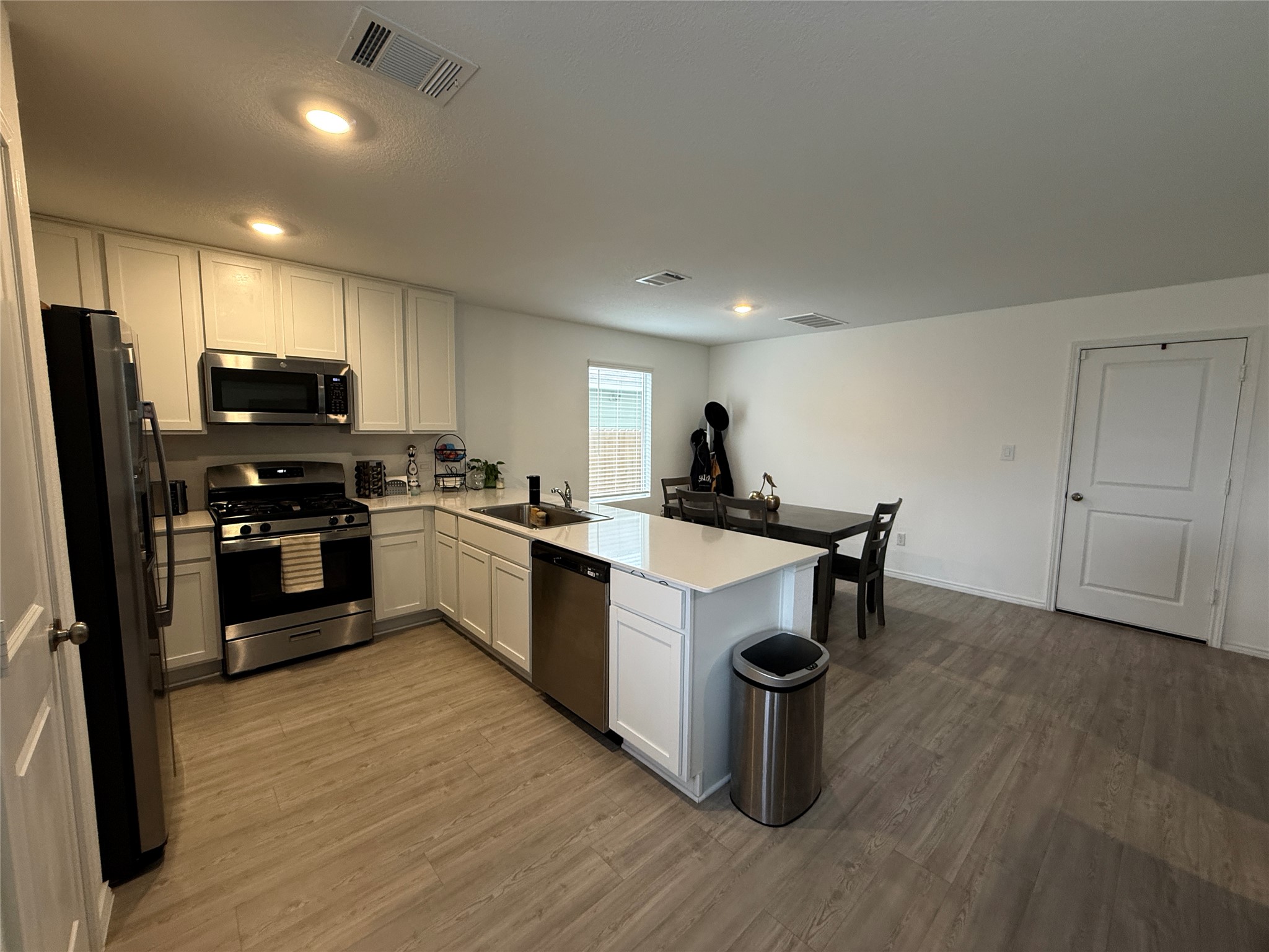 23420 Tiny Moons Way Elgin, TX 78621 - Photo 9 of 22 a kitchen with kitchen island a counter top space a sink and appliances