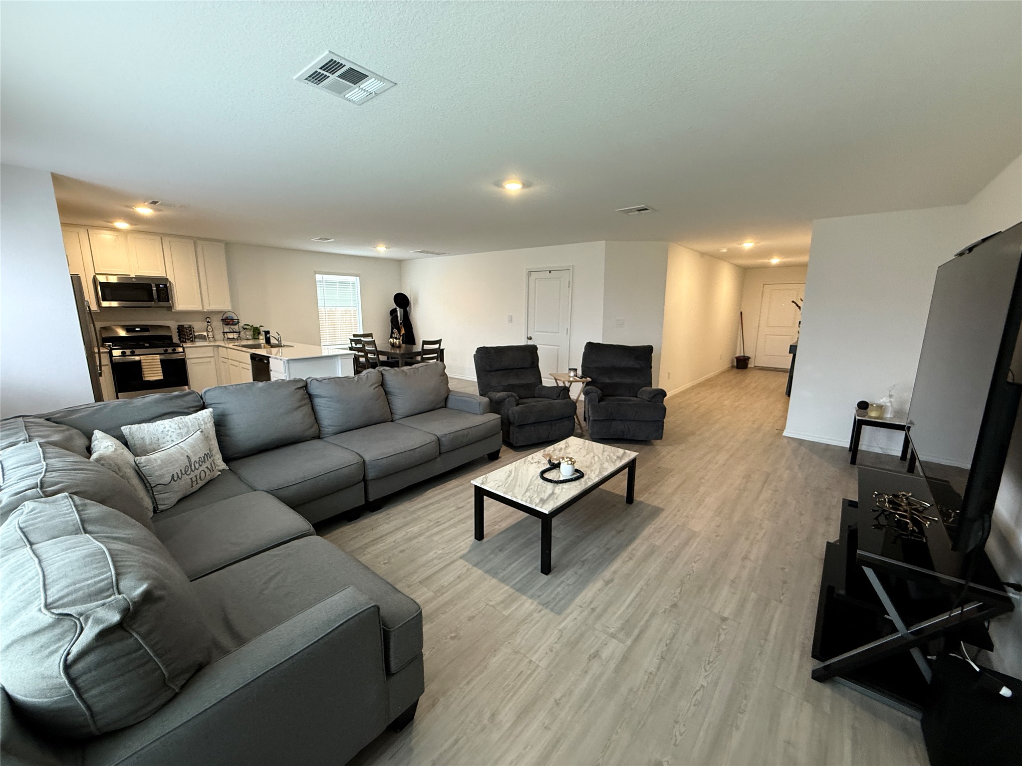 23420 Tiny Moons Way Elgin, TX 78621 - Photo 10 of 22 a living room with furniture or wooden floor and a flat screen tv