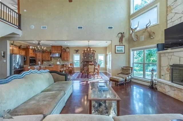 a living room with fireplace furniture and a large window