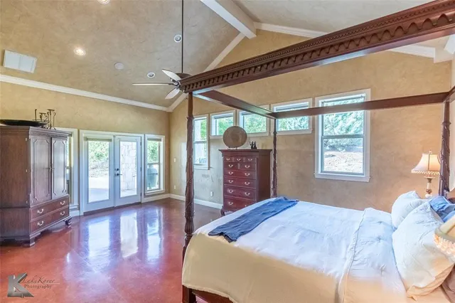 a bedroom with a large bed and a large window