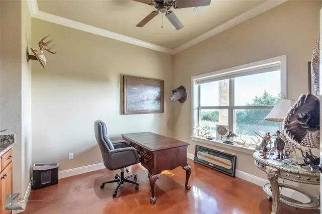 a work room with furniture and a large window