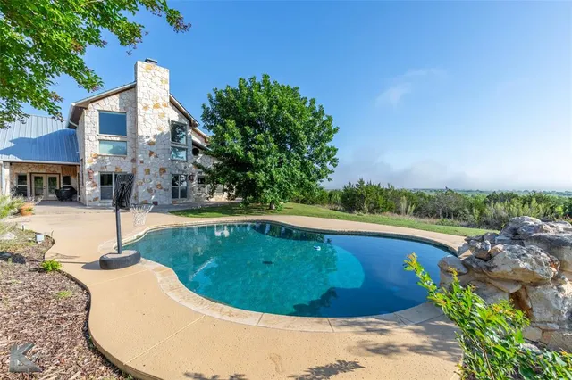 a view of swimming pool with a yard