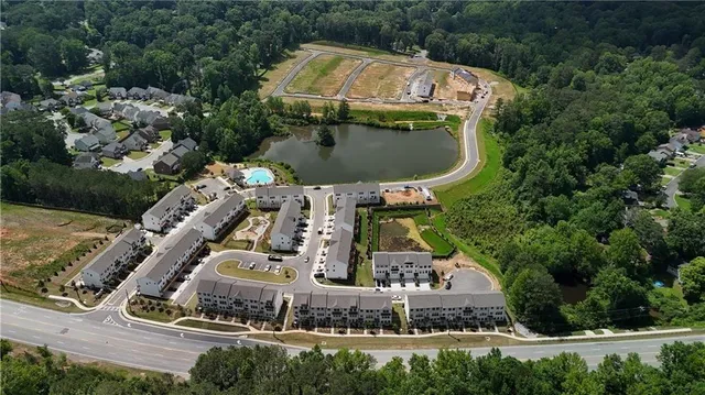 an aerial view of a house with a garden and trees