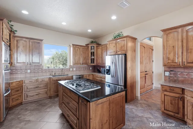 a kitchen with a refrigerator a sink and a stove