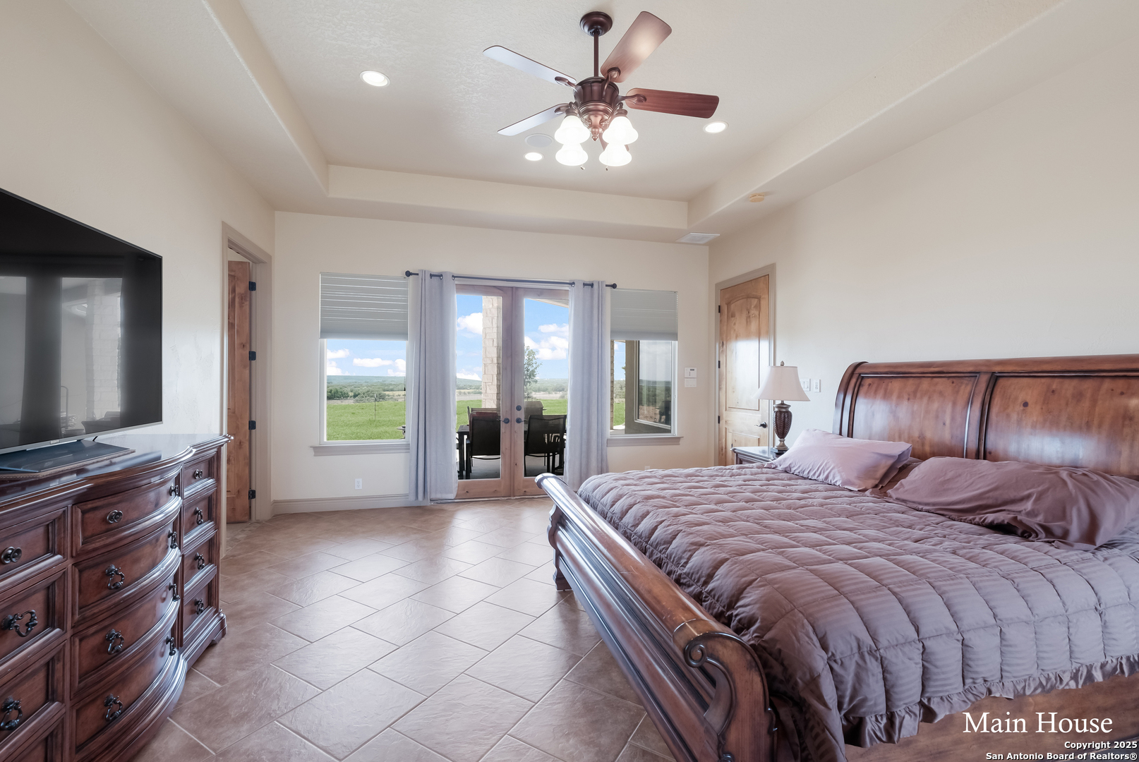 208 Private Road 378 Rio Medina, TX 78066 - Photo 7 of 30 a spacious bedroom with a bed and glass windows