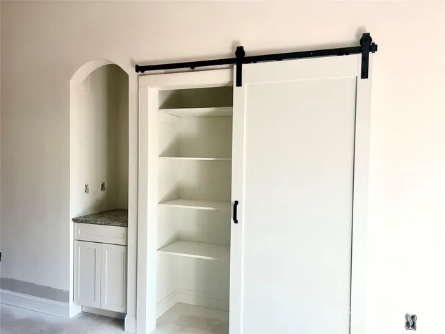 a bathroom with a shower and a sink