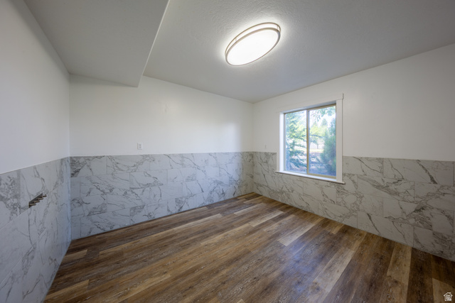 868 Braddock Lane Alpine, UT 84004 - Photo 51 of 64 Room featuring wood-finish flooring, white walls, and a window providing natural light