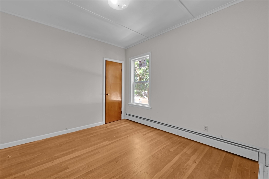 47 Morris Street Southbridge, MA 01550 - Photo 6 of 40 an empty room with wooden floor and windows