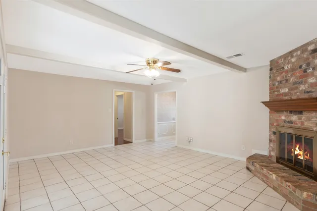 a view of an empty room with a fireplace