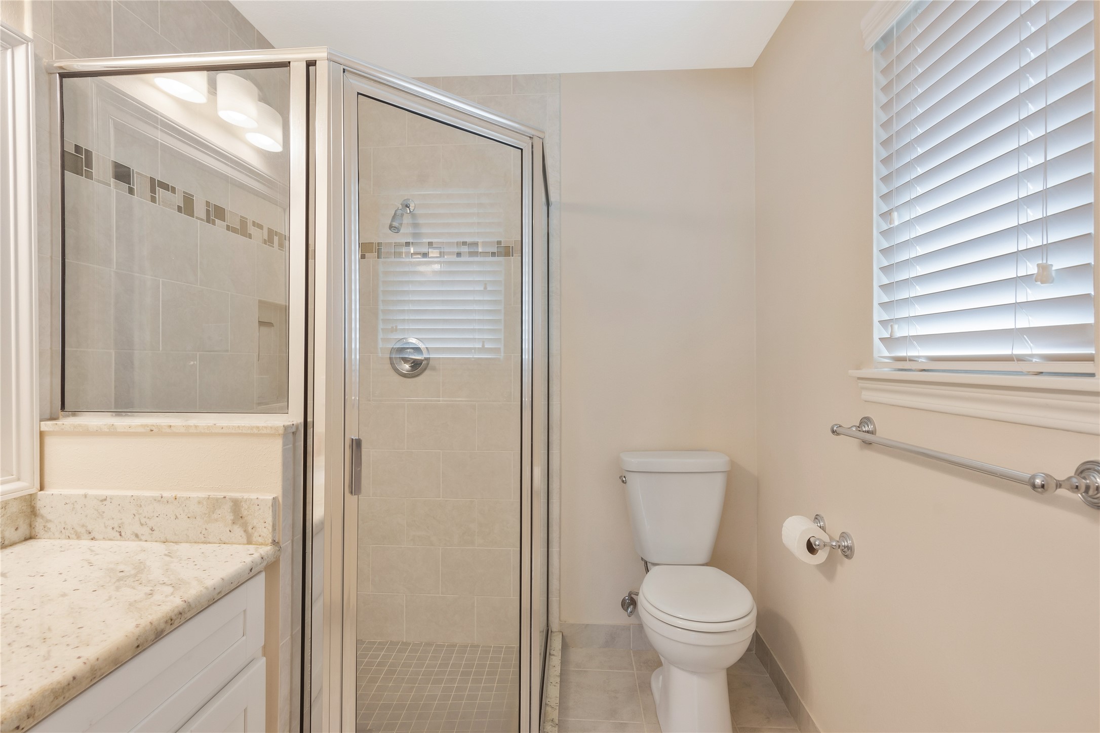17926 Cypress Spring Drive Spring, TX 77388 - Photo 23 of 34 a bathroom with a granite countertop toilet a sink and shower