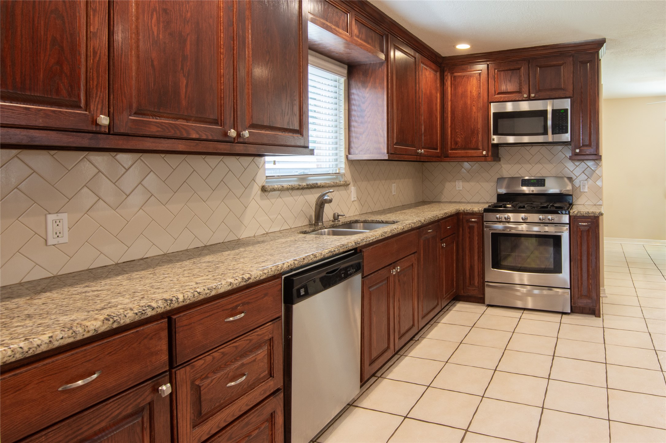 17926 Cypress Spring Drive Spring, TX 77388 - Photo 10 of 34 a kitchen with stainless steel appliances granite countertop a sink stove and microwave
