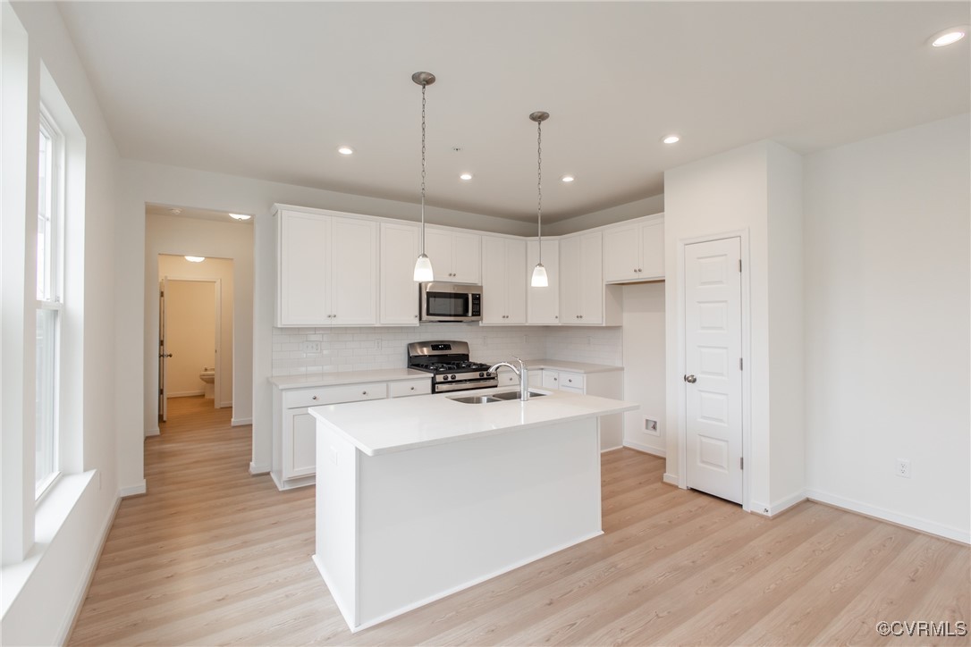 5320 Good Landing Road, Unit 103 Glen Allen, VA 23059 - Photo 4 of 37 a kitchen with stainless steel appliances a stove top oven a sink and a refrigerator
