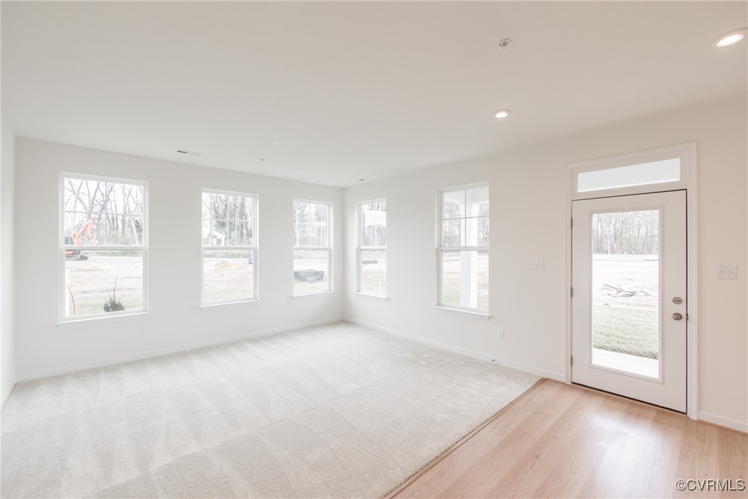 5320 Good Landing Road, Unit 103 Glen Allen, VA 23059 - Photo 7 of 37 a view of an empty room with a window and wooden floor