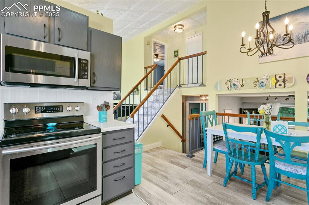 2960 Rio Vista Drive Colorado Springs, CO 80917 - Photo 13 of 32 a kitchen with a stove and a microwave
