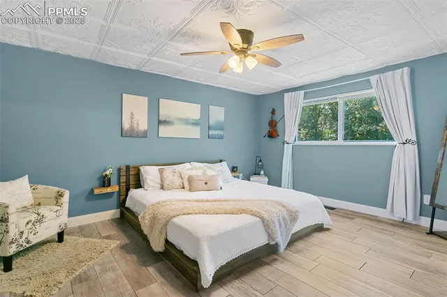 a bedroom with a bed and a chandelier