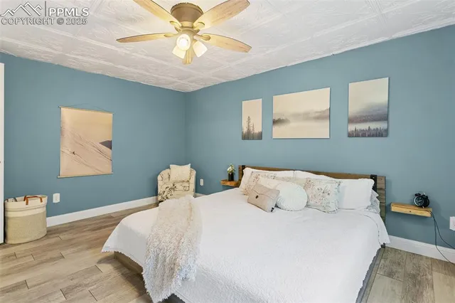 a bedroom with a bed and a chandelier