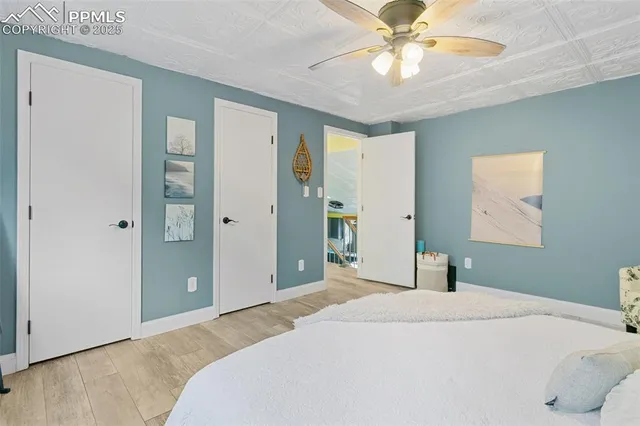 a bedroom with a bed and a chandelier